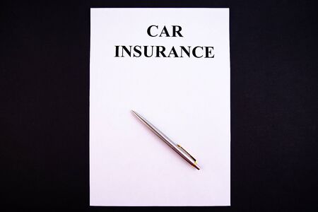 Insurance form with pen on a black backgroundの写真素材