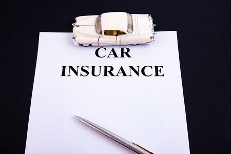 Insurance form with pen on a black backgroundの写真素材