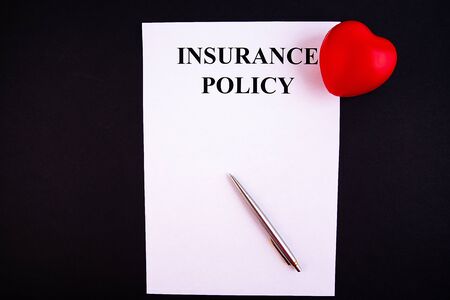 Insurance form with a toy car on a black backgroundの写真素材