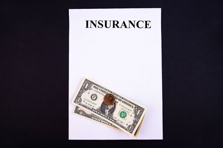 Insurance form with money on a black background