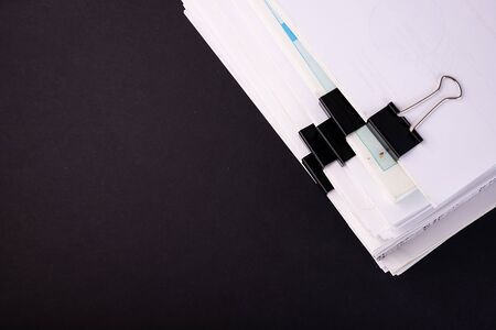 The concept of budget planning in accounting. A business woman is surrounded by large stacks of documents.の写真素材