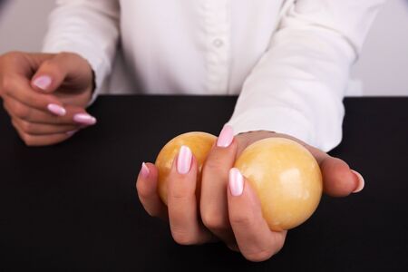 Two stone balls in a female hand. Man Strength Concept, Human Management, Men's Health Secrets, Men's Healthの写真素材