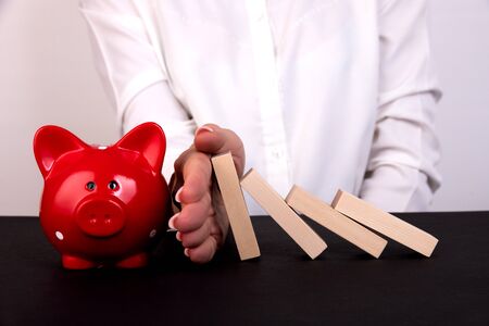 Businesswoman hand Stopping Falling wooden Blocks or Dominoes. Business, Risk Management, Solution,...