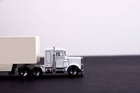 Toy truck on a black table with a white place for inscriptionの写真素材