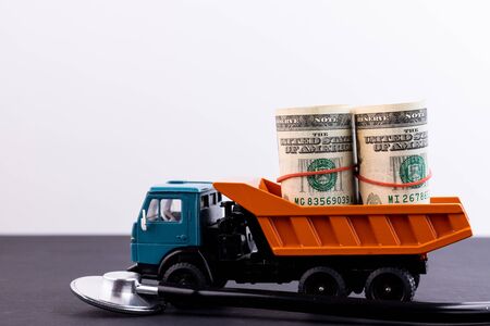 Truck with a load of money and a stethoscope on a black backgroundの写真素材