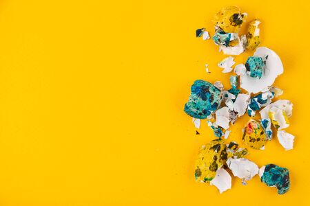 Colored eggshell from easter eggs on a yellow background