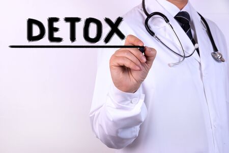 Doctor holding a card with DETOX, Medical conceptの写真素材