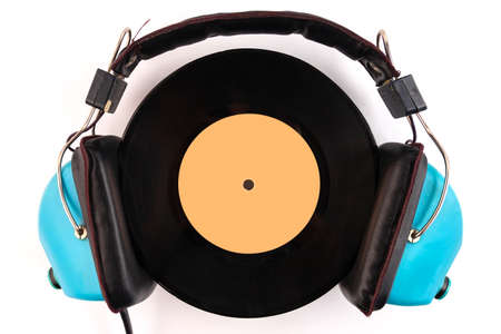 Vinyl record and headphone on a white background. Audio enthusiast,music lover or professional DJ...