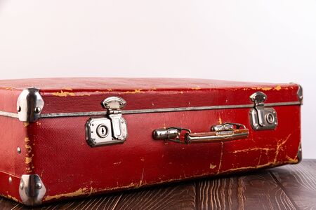 Old suitcase on the table against white background.の写真素材