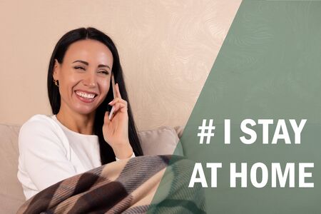 Happy woman with laptop and smartphone during quarantine at home: I Stay at home social media...
