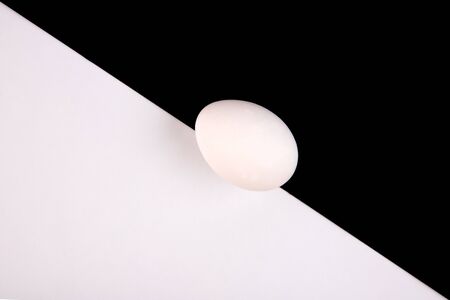 Chicken eggs on a black and white background. Minimalism. Egg on a black and white background. View...