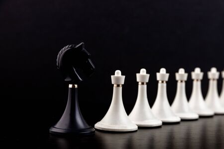 White chess pieces on a chessboard on a dark background. Business concept. Game, strategy, wisdom, determination.の写真素材
