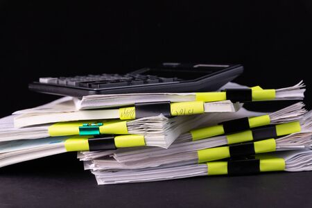 Pile of documents with black clips Clamped stacked on the desk in the office.