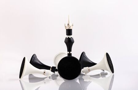 White and black chess pieces on a reflective surface. Business concept. Game, strategy, wisdom,...