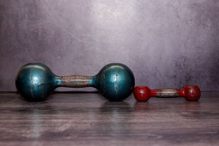 Old gym equipment on floor. Fitness or bodybuilding concept background