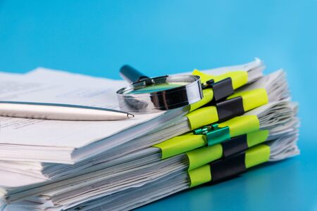 Magnifying glass, ballpoint pen close-up on white paper for notesMagnifying glass, ballpoint pen...
