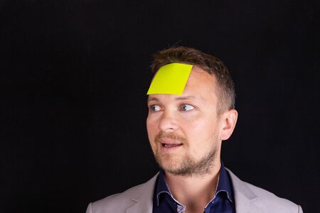 Businessman with a blank sticker on his face. Business strategy, idea, concept.