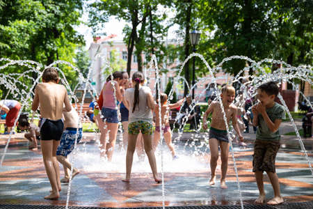 GOMEL, BELARUS - June 18 2020: Children bathe in a fountain in a city park.のeditorial素材