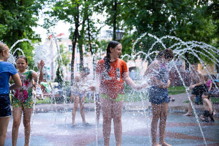 GOMEL, BELARUS - June 18 2020: Children bathe in a fountain in a city park.のeditorial素材