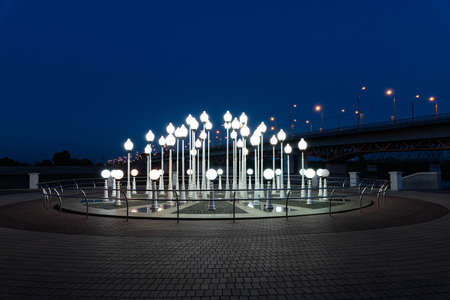 Evening glow of lanterns in the park. Installation