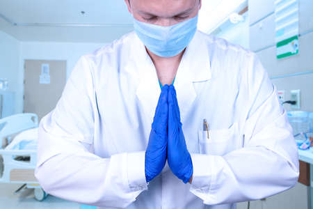 The friendly doctor hands are folded in a gesture of peace to encourage, empathize, greet, and...