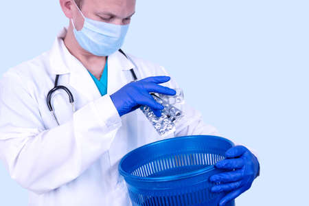 Placebo effect. Doctor throws pills into a garbage bin. Medical concept.