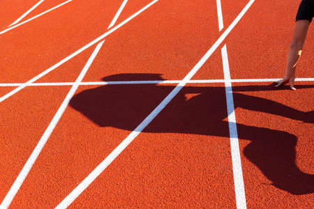 Athletics, treadmill in a stadium with a shadow from a man. Quarantine concept and COVID-19