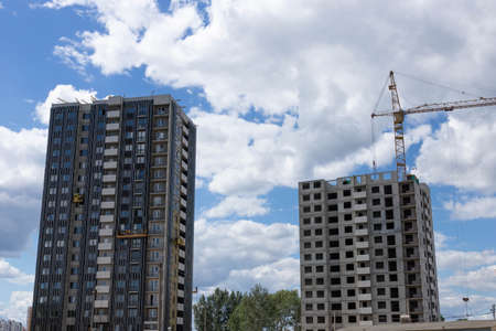 Building under construction, workflow, construction projects, insulation and facade finishing.