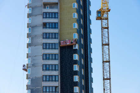 Thermal insulation of a high-rise residential building under construction.