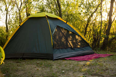 Summer tourist tent on a background of nature. The concept of travel and outdoor activities.