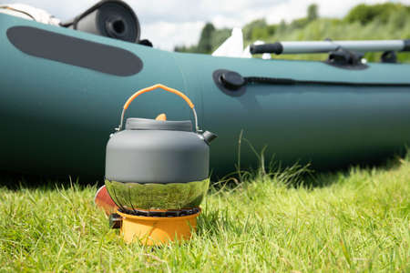 Tourist kettle on a gas burner. Cooking in field conditions. Using a tourist gas burner