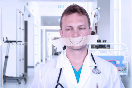 Medical ethics concept. Doctor with sticky tape adhesive tape.の写真素材