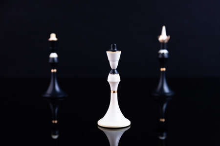 The concept of choice, merger and acquisition. Chess pieces on a black background. Selective focus.の写真素材