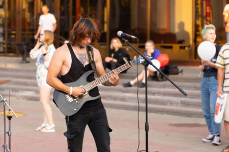 MINSK, BELARUS - AUGUST 23 2020: A concert of a rock band on a city street surrounded by spectators. Selective focusのeditorial素材