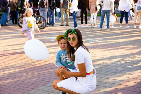 MINSK, BELARUS - AUGUST 23 2020: Child with mom and a balloon at the holiday.のeditorial素材