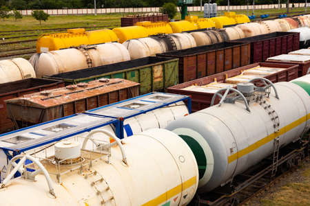 Tanks with fuel, wagons with cargo at a freight railway station. Logistics and transportation...