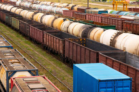 Tanks with fuel, wagons with cargo at a freight railway station. Logistics and transportation concept.の写真素材