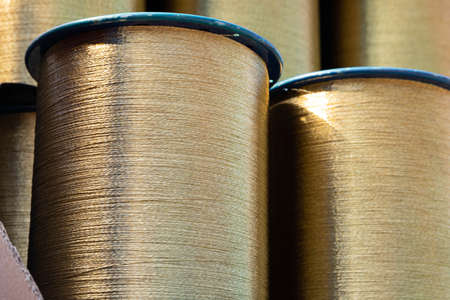 Spiral brass wire wound on a spool, ready for shipment.