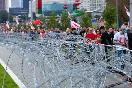 Minsk, Belarus - September 20, 2020: Peaceful protests in Belarus. People at a protest rally in Belarus behind barbed wire. Strike in Belarus. Selective focus.のeditorial素材
