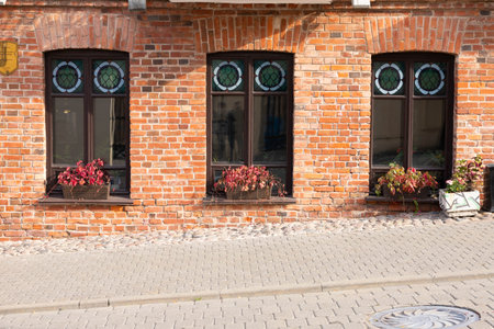 Windows on the facade of an old European stone houseの写真素材