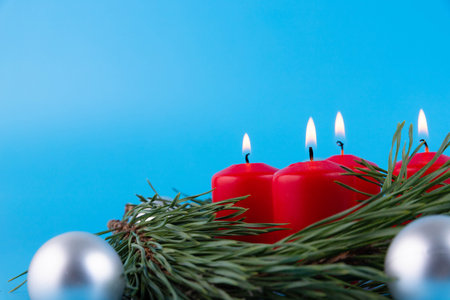 Christmas and New Year burning candles, with Christmas toys and a Christmas treeの写真素材