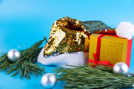 Creative Christmas composition. Greeting card, invitation or flyer. Golden hat of Santa Claus and...