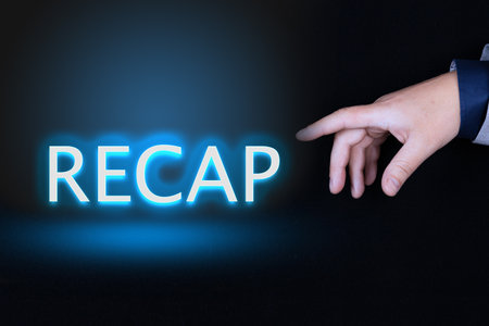 RECAP text is a word written in neon letters on a black background pointed to by a hand with a person's index finger.の写真素材