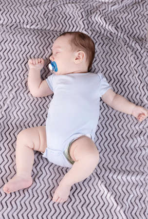 Adorable baby sleeping relaxed and sprawl in parent's bed