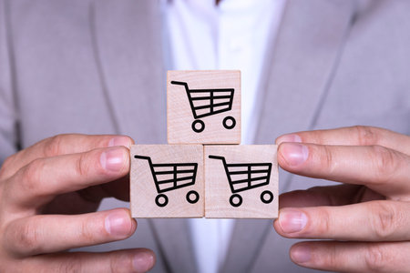 Increasing sales makes business successful, pyramid of cubes with a shopping cart icon and symbol.