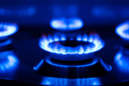Gas flame, burning burner of a gas stove on a black background.