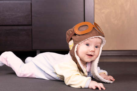 Baby aviator, wearing a pilot hat, close up portrait.