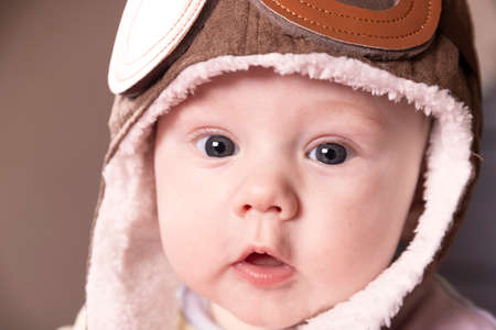 Baby aviator, wearing a pilot hat, close up portrait.の写真素材