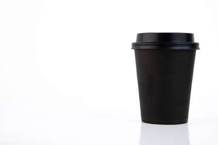 Black paper coffee cup with plastic lid on a white background. Copy space.の写真素材