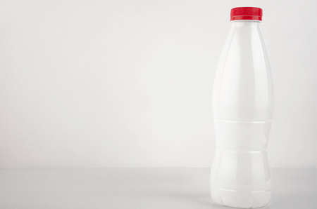 White plastic bottle for milk on a white background. Copy spaceの写真素材